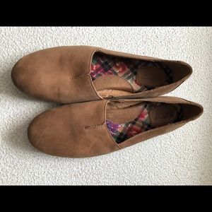 Slip on tan suede shoes.